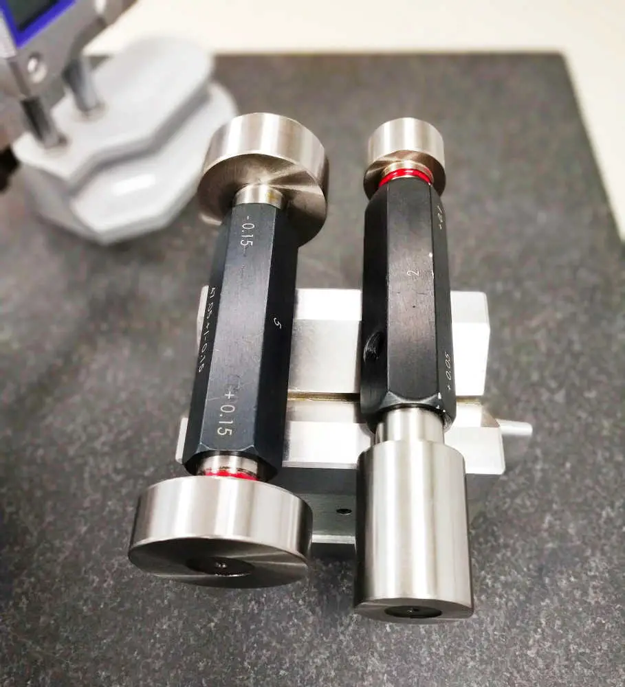 Two plug gauges sit on V block