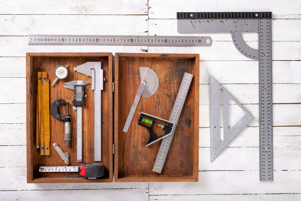 Combination square (near protractor) and other measuring tools